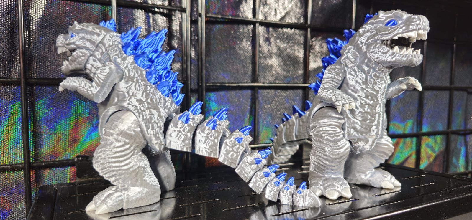 Silver and blue articulated Godzilla print roaring, with blue dorsal spikes